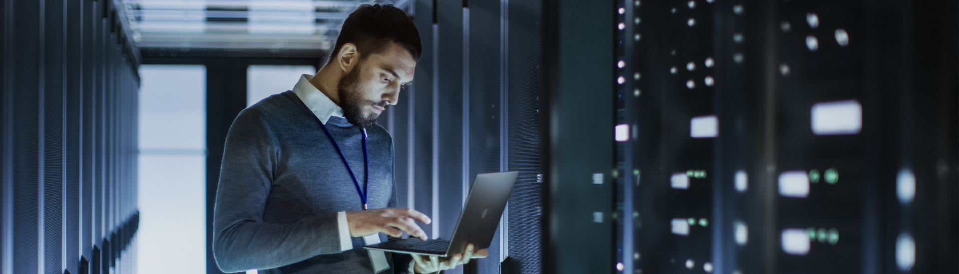 Professional with a Laptop in Server Room